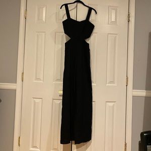Black zip up jumpsuit with cutout on sides